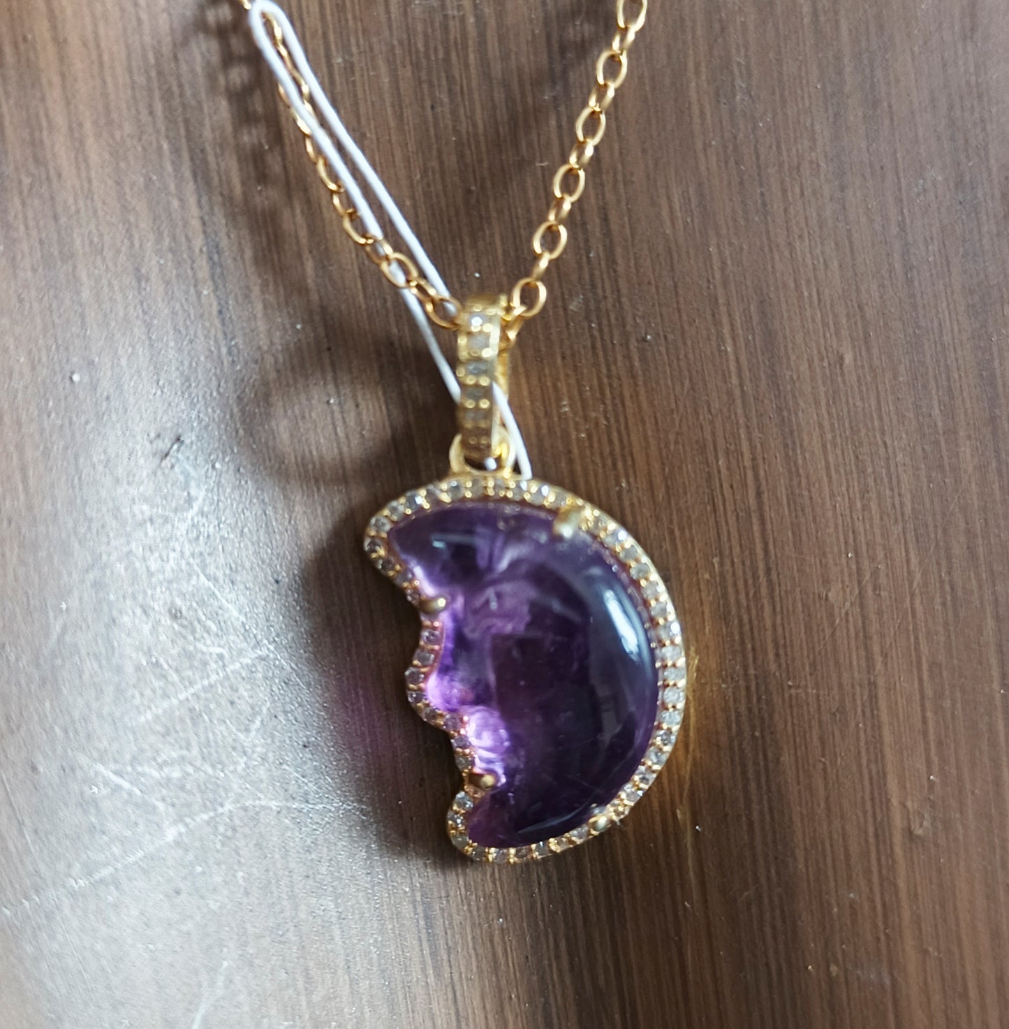 Moon-shaped sterling silver pendant with Amethyst centerpiece and diamond border