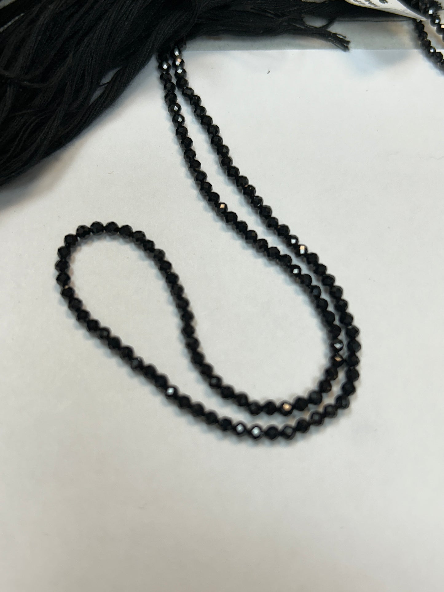 BLACK SPINEL ROUND FACETED 2-2.50 MM