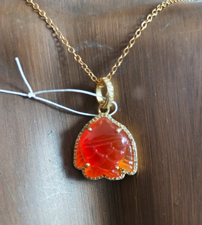 Fish-shaped sterling silver pendant with Orange jade centerpiece and diamond border
