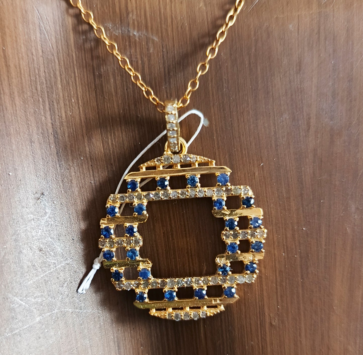 Round shaped sterling silver pendant with Diamond And Blue Sapphire