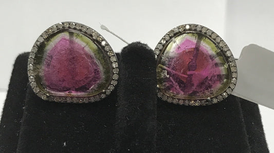 A pair of tourmaline watermelon and diamond earrings, with a gold and silver color scheme, displayed on a black mannequin.